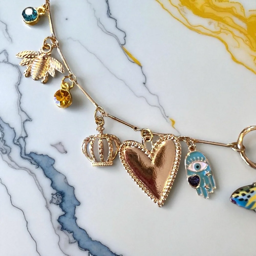 Unique and Gorgeous Gold toned Necklace with Varying Blue and Yellow Charms